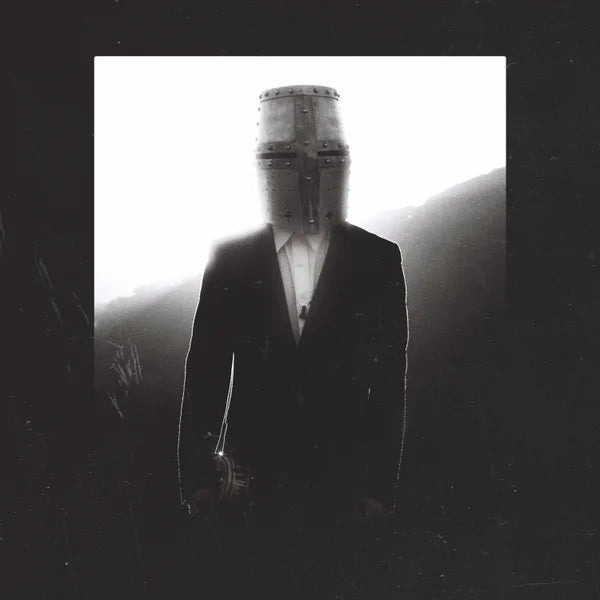 Barricades cover artwork: a lone figure in a dark suit and metal helmet, framed by dark film texture